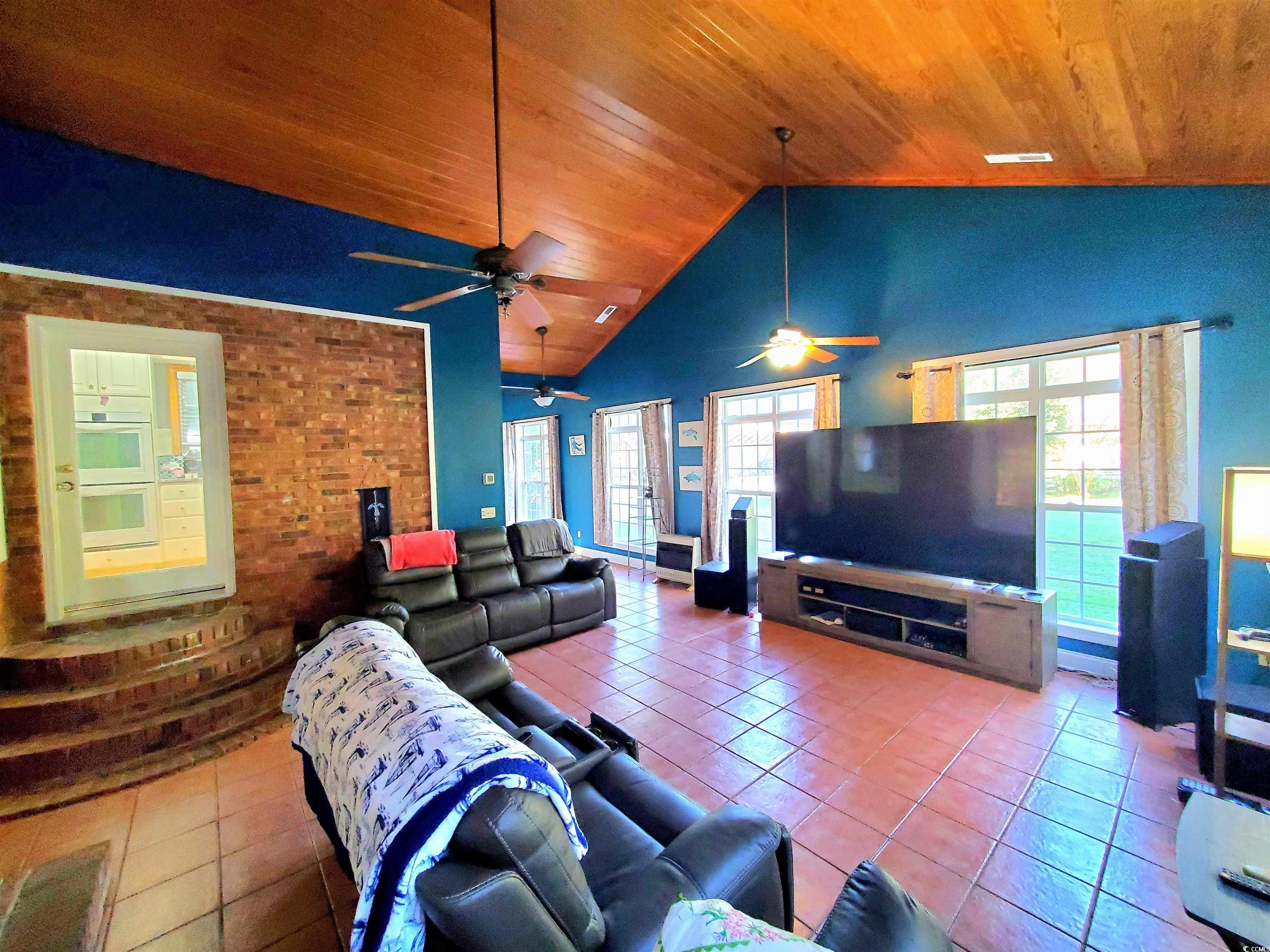 1484 Fitch Road Lake City, SC 29560 - Photo 17 of 40 Living room featuring tile patterned floors, high vaulted ceiling, and wooden ceiling