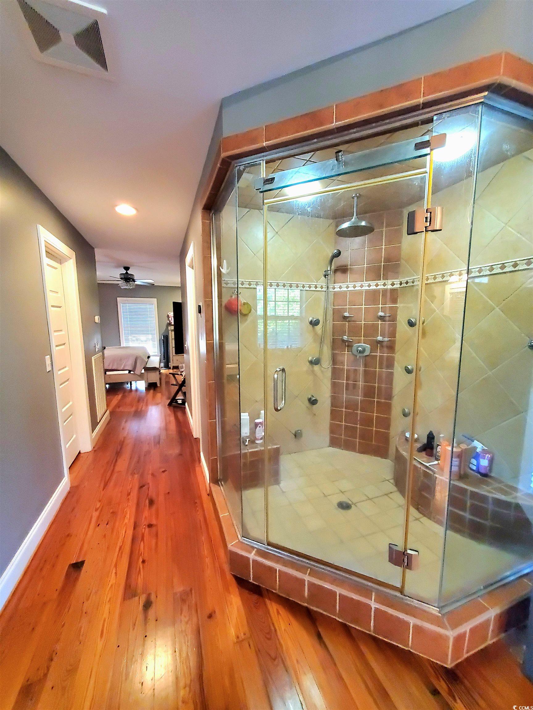 1484 Fitch Road Lake City, SC 29560 - Photo 22 of 40 Ensuite bathroom with hardwood / wood-style floors, a stall shower, and recessed lighting