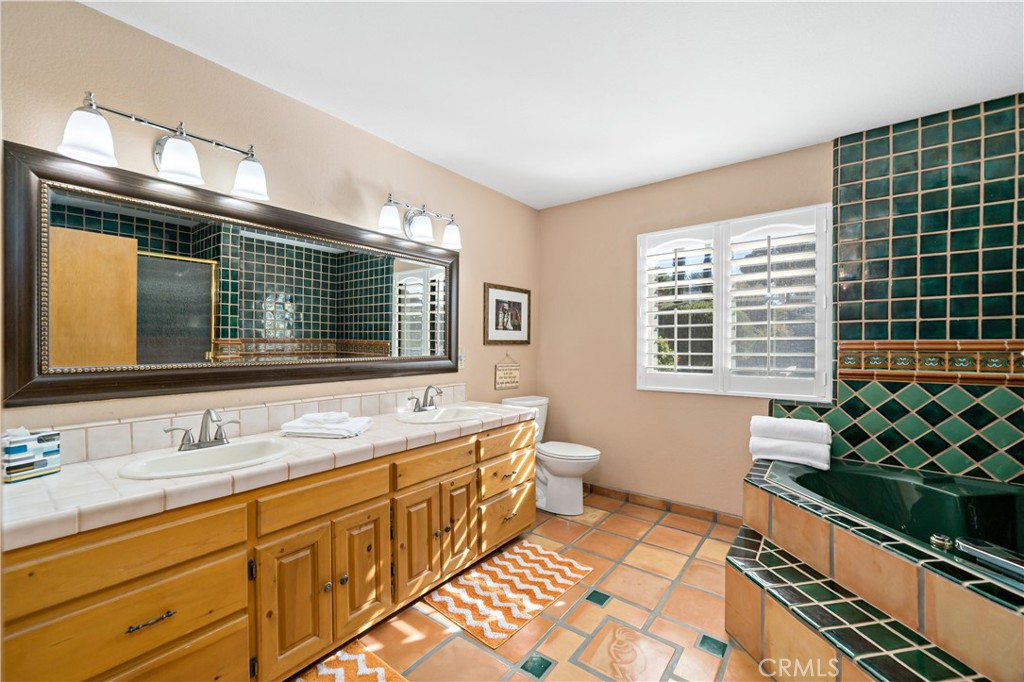 40995 Vía Fernando Temecula, CA 92592 - Photo 23 of 52 a bathroom with a double vanity sink mirror and toilet
