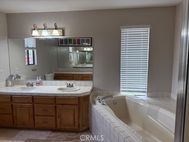 40995 Vía Fernando Temecula, CA 92592 - Photo 32 of 52 a bathroom with a tub sink and mirror