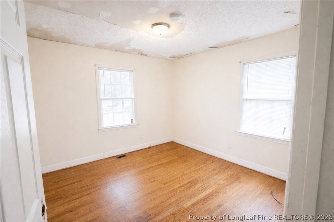 107 East Thigpen Road Conetoe, NC 27819 - Photo 12 of 13 an empty room with wooden floor and windows