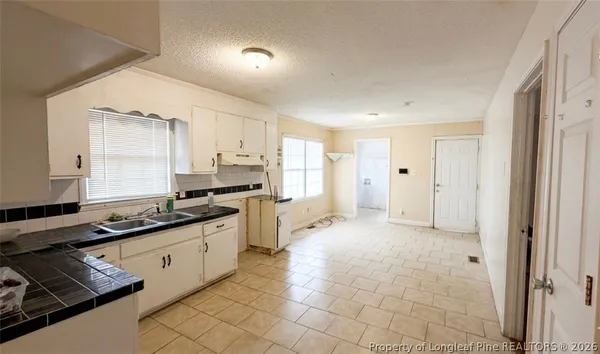 a kitchen with stainless steel appliances a sink stove and cabinets