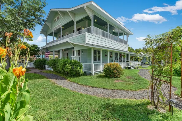 a front view of a house with garden
