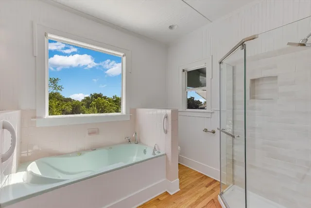 a bathroom with a tub and a shower