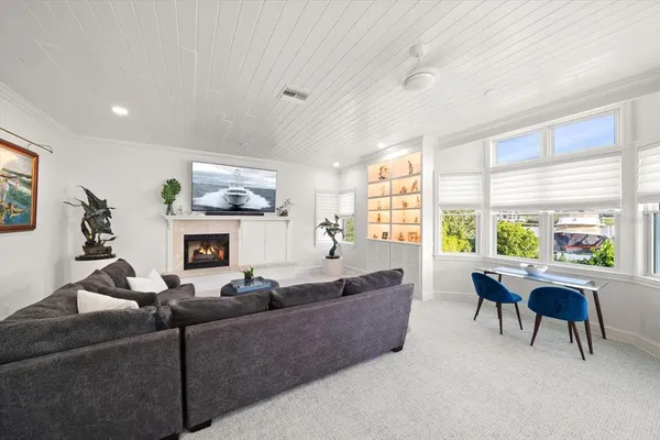 a living room with furniture a fireplace and a flat screen tv