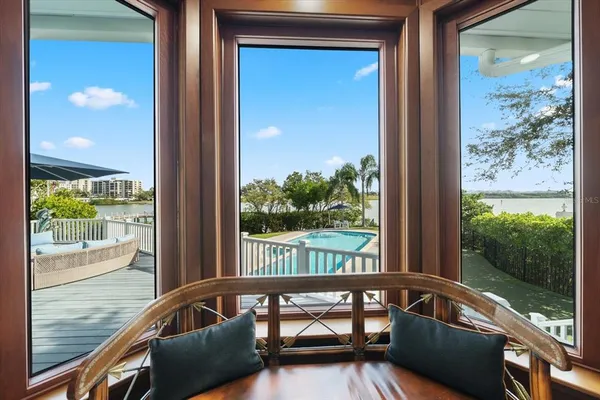a bedroom with furniture and a large window