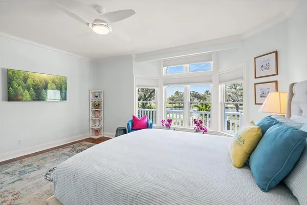 a spacious bedroom with a bed and a chair