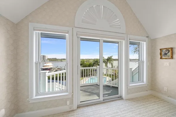 a view of a roof deck with couches and wooden fence