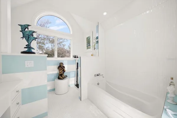a view of a balcony with wooden floor and outdoor seating
