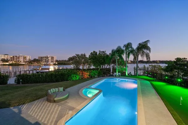 a kitchen with stainless steel appliances granite countertop a sink a stove and a wooden cabinets