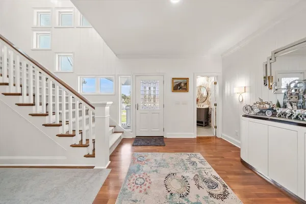 a living room with furniture a fireplace and a large window
