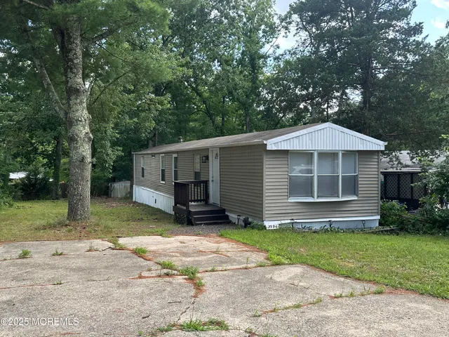 a house that has a tree in front of the house
