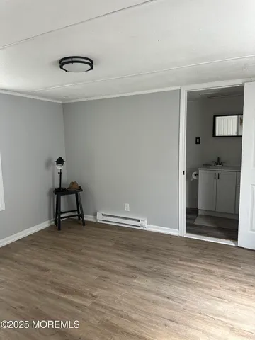 a view of an empty room with wooden floor