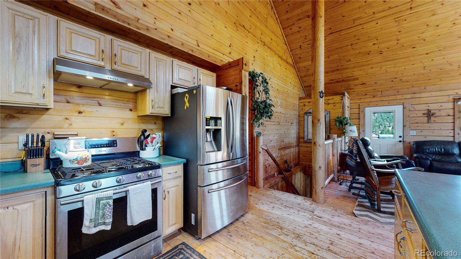 688 Beartrap Road Red Feather Lakes, CO 80545 - Photo 12 of 40 a kitchen with stainless steel appliances a stove a refrigerator and cabinets