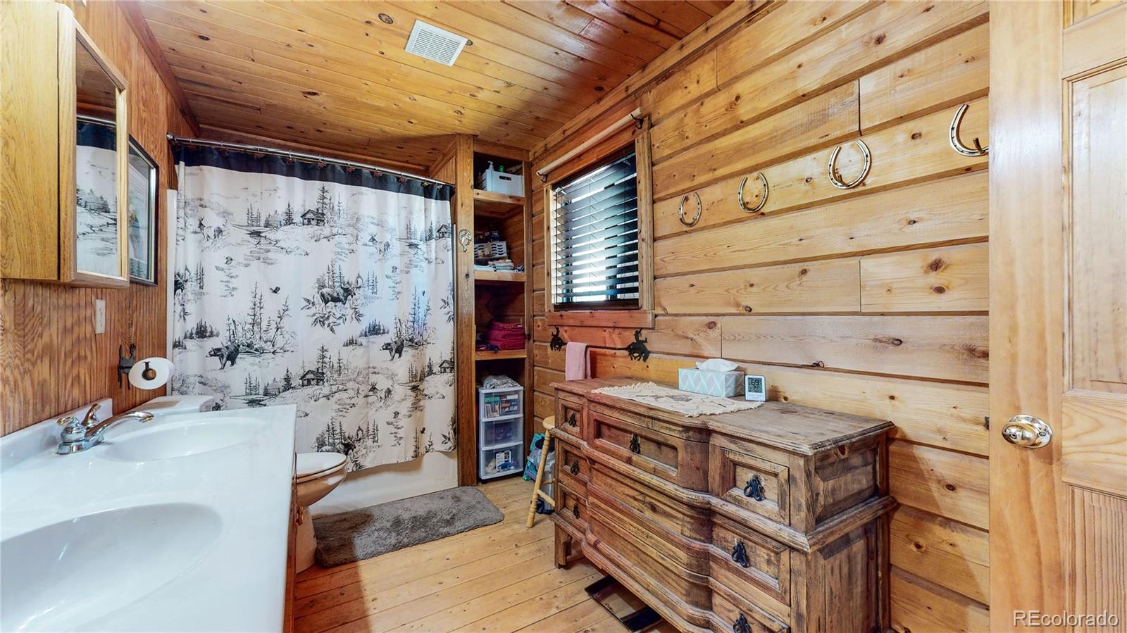 688 Beartrap Road Red Feather Lakes, CO 80545 - Photo 19 of 40 a bathroom with a sink and a mirror