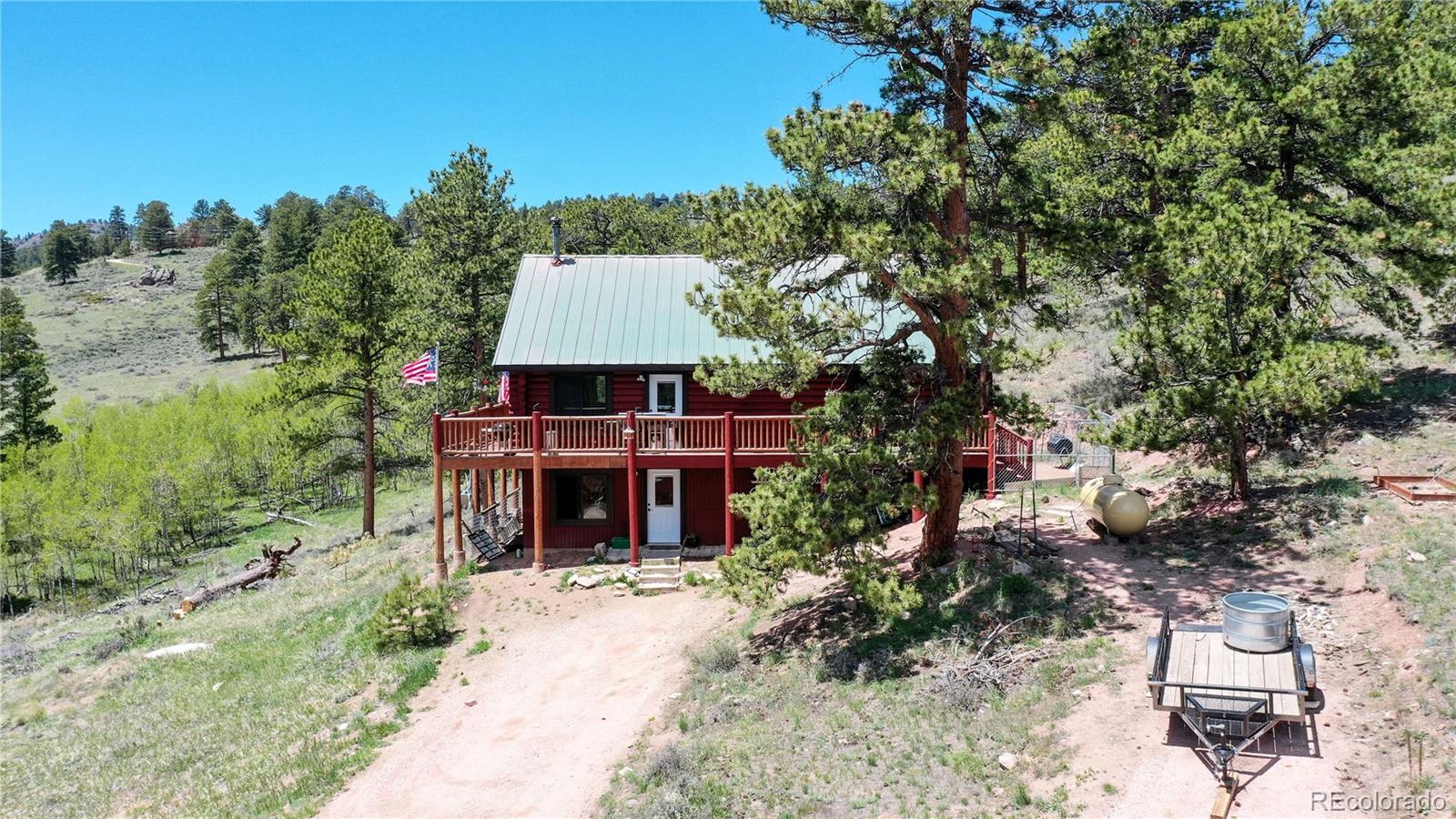 688 Beartrap Road Red Feather Lakes, CO 80545 - Photo 2 of 40 a view of a patio with furniture and a garden