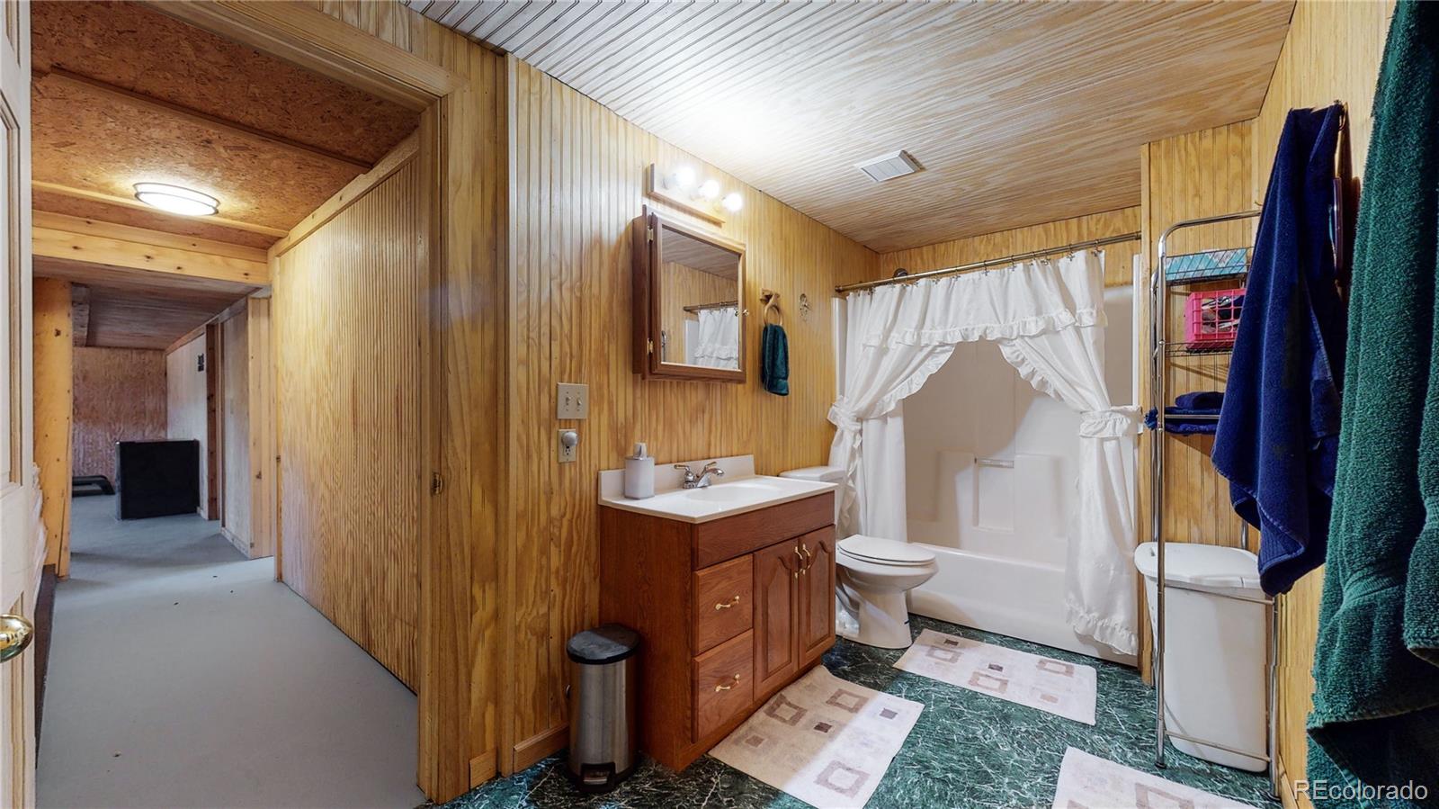 688 Beartrap Road Red Feather Lakes, CO 80545 - Photo 27 of 40 a bathroom with a toilet sink and mirror