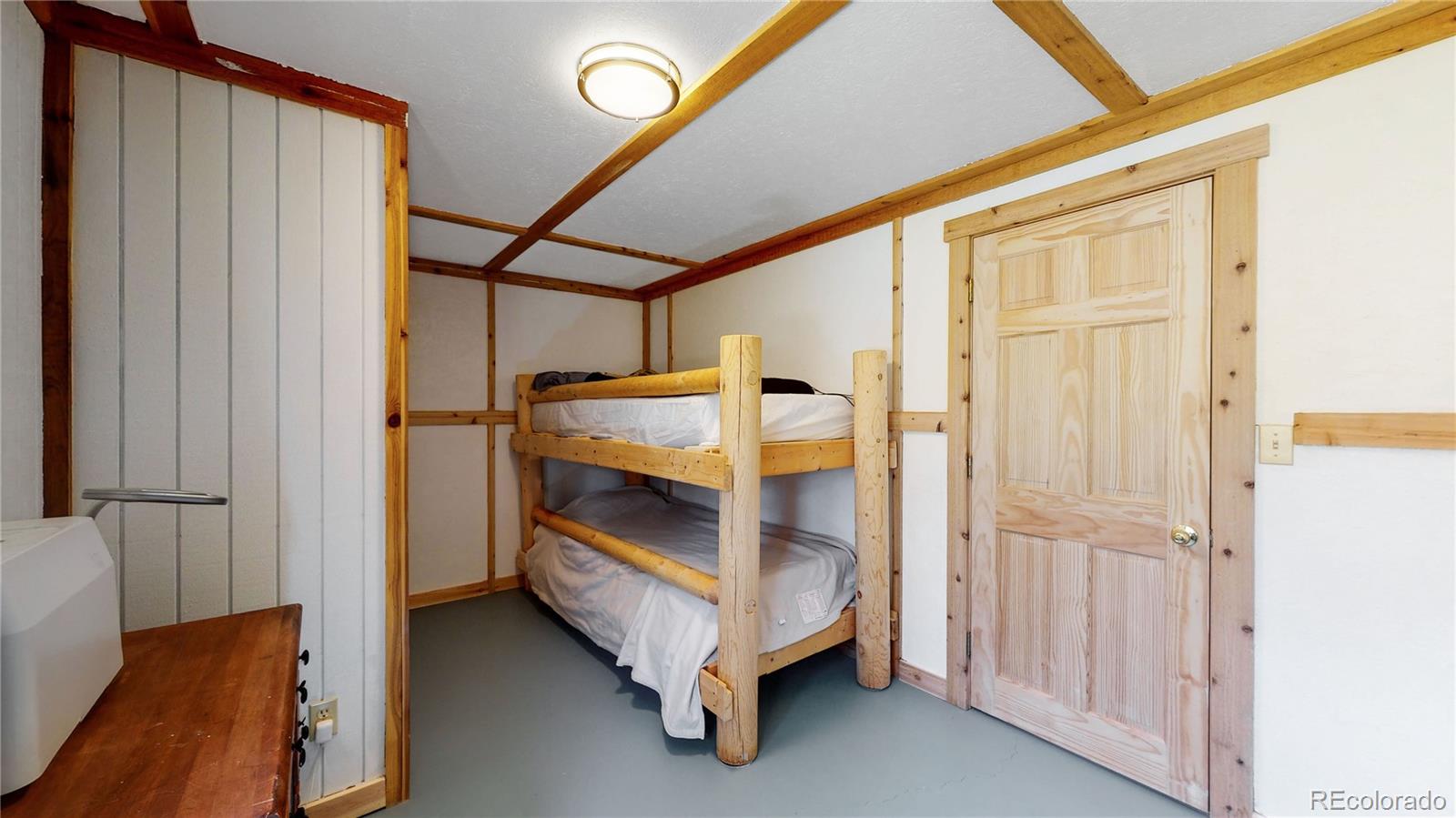 688 Beartrap Road Red Feather Lakes, CO 80545 - Photo 28 of 40 a bed room with a bed and a window