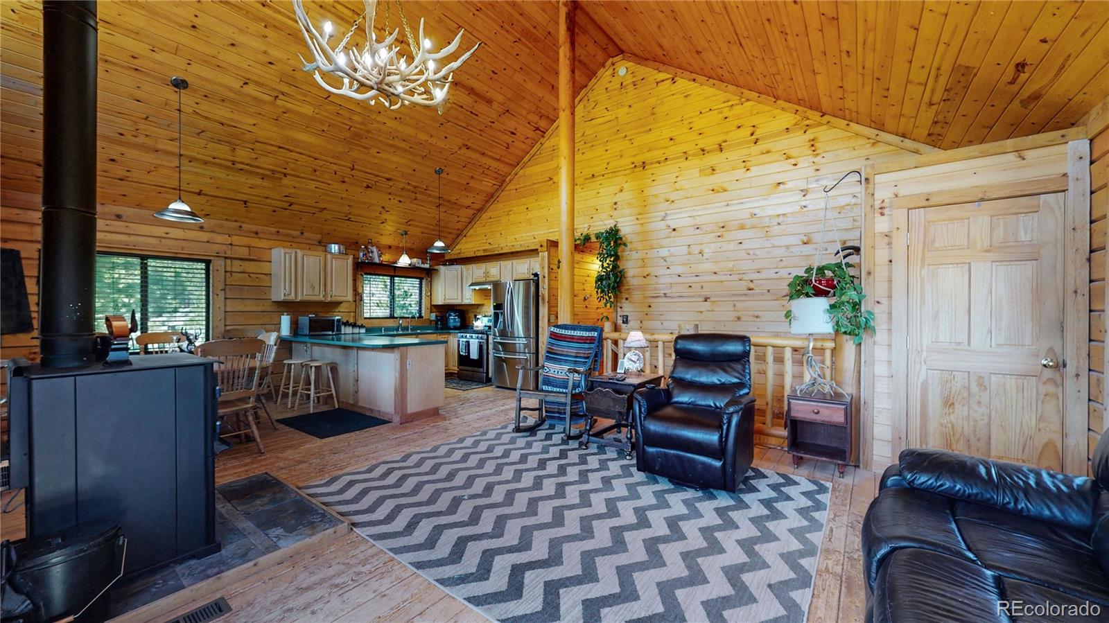 688 Beartrap Road Red Feather Lakes, CO 80545 - Photo 4 of 40 a living room with furniture and a fireplace