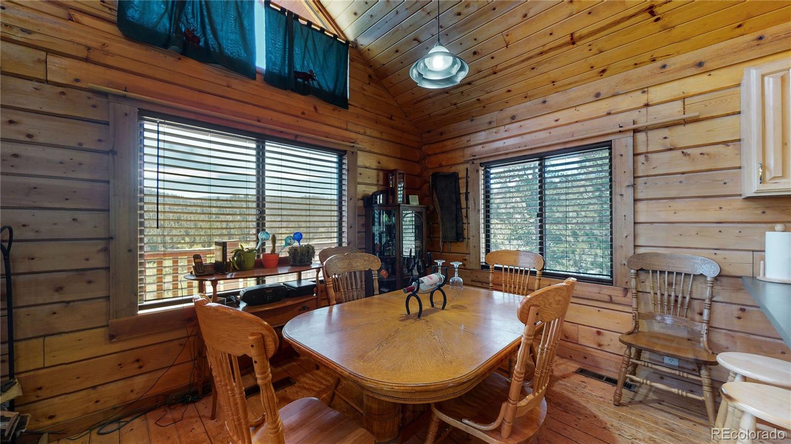 688 Beartrap Road Red Feather Lakes, CO 80545 - Photo 8 of 40 a view of a patio with table and chairs