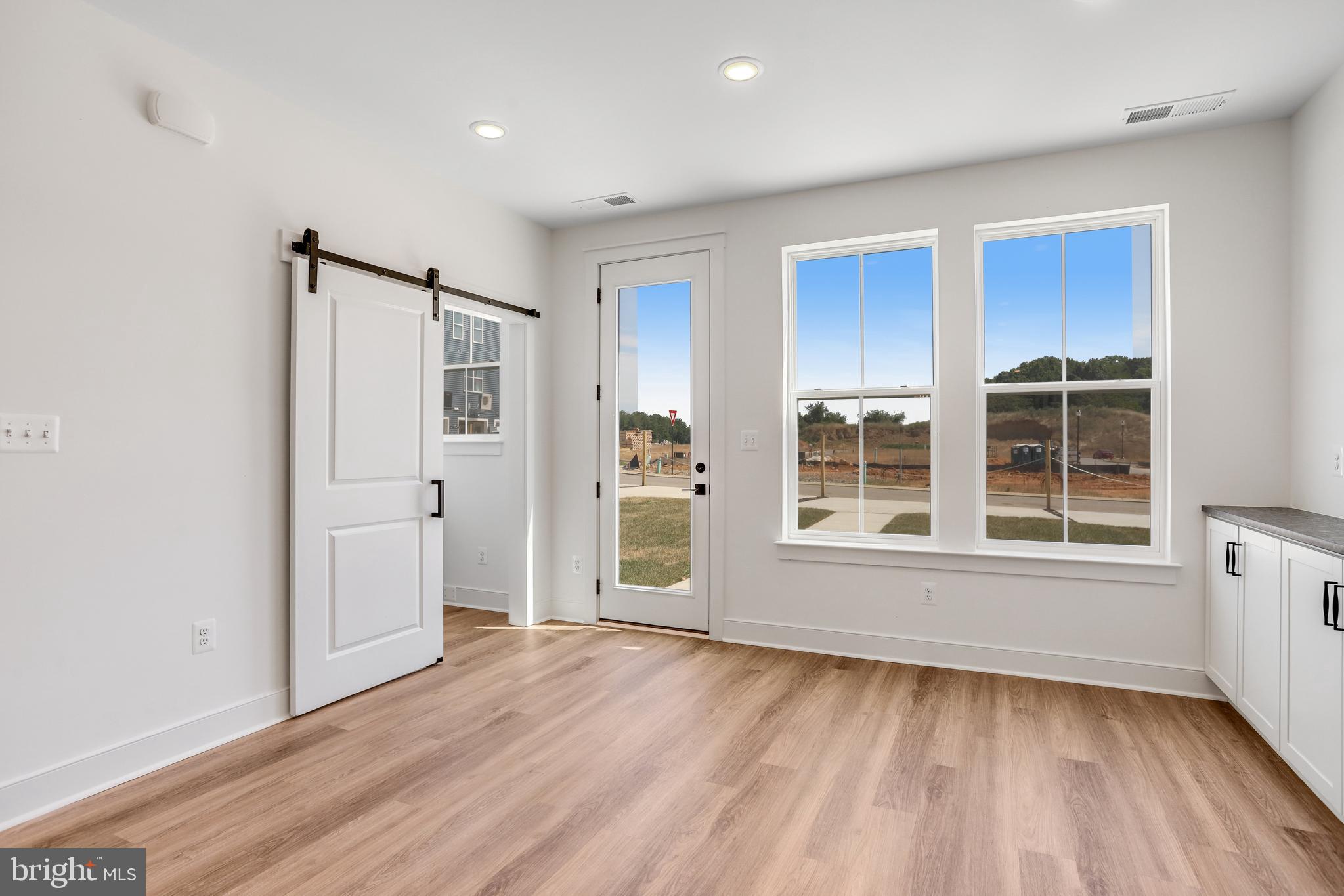 1803 Shookstown Road Frederick, MD 21702 - Photo 12 of 35 a view of an empty room with a window and wooden floor