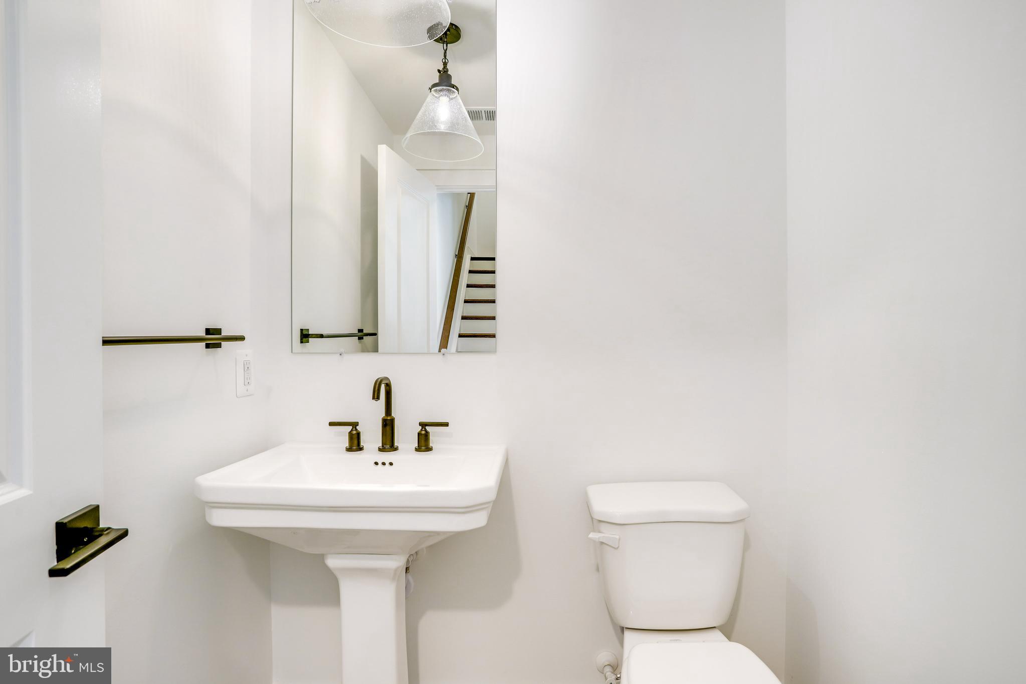 1803 Shookstown Road Frederick, MD 21702 - Photo 17 of 35 a bathroom with a toilet sink and mirror