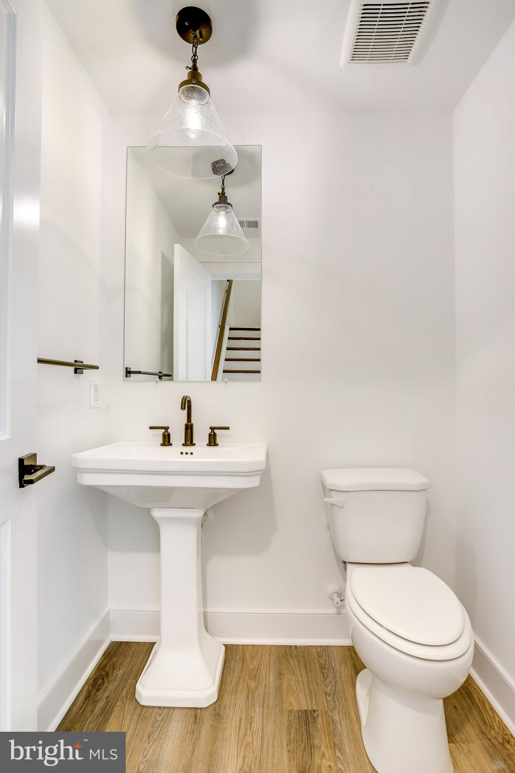 1803 Shookstown Road Frederick, MD 21702 - Photo 18 of 35 a bathroom with a sink a toilet and mirror