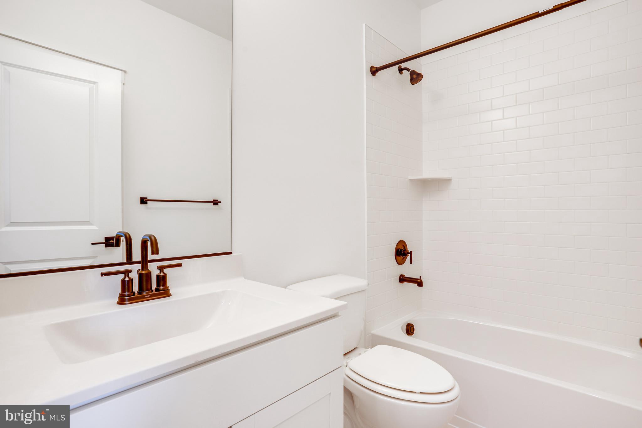 1803 Shookstown Road Frederick, MD 21702 - Photo 30 of 35 a bathroom with a sink a toilet and a tub