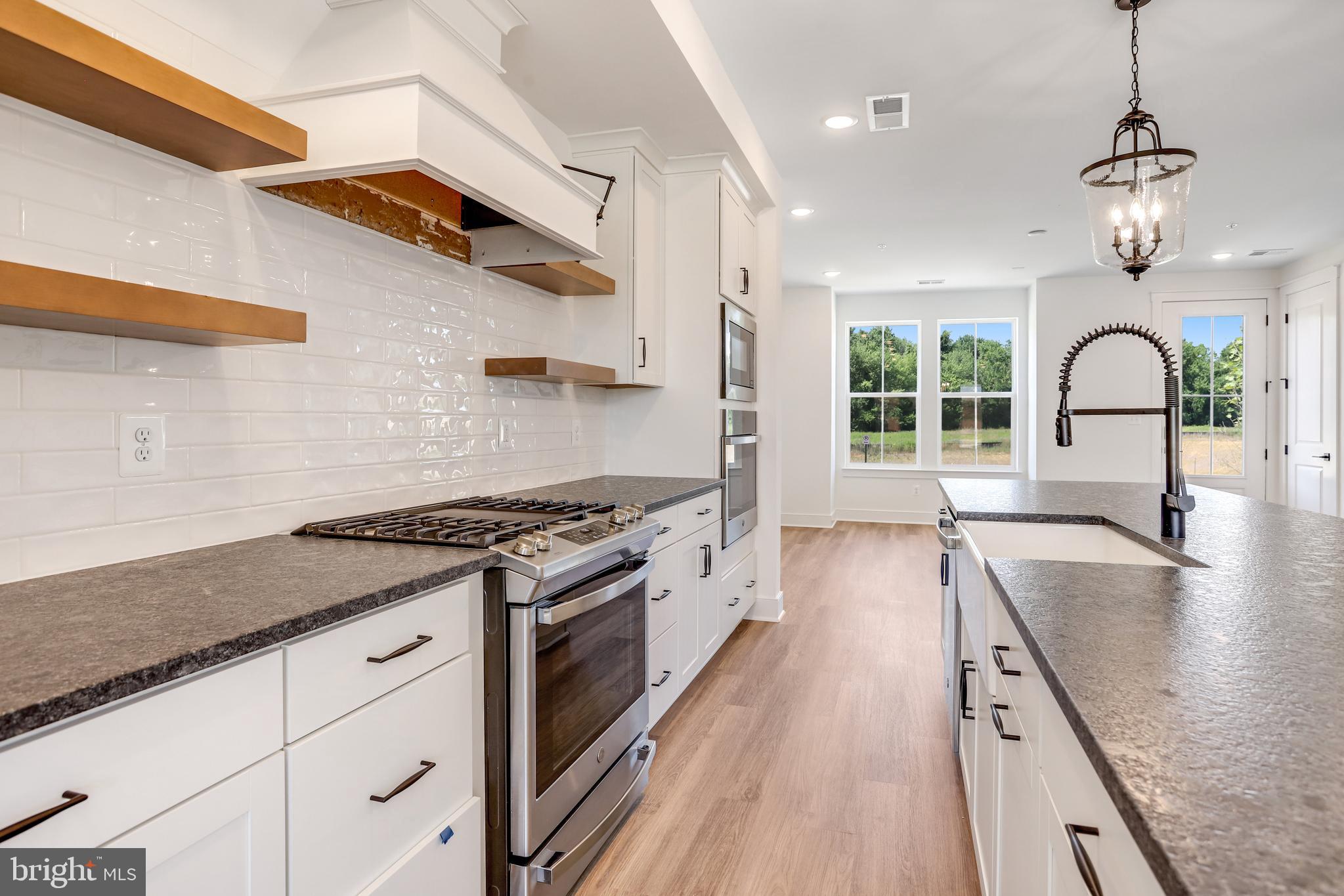 1803 Shookstown Road Frederick, MD 21702 - Photo 9 of 35 a kitchen with stainless steel appliances granite countertop a stove and a sink