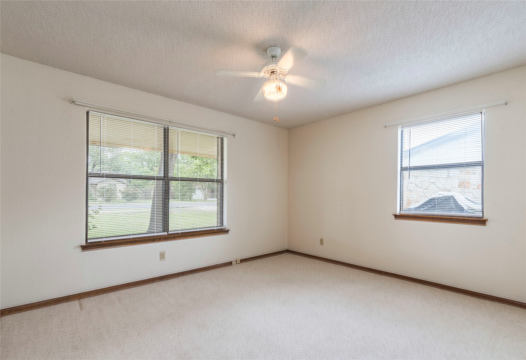 13505 Broadmeade Avenue Austin, TX 78729 - Photo 13 of 21 Unfurnished room with a textured ceiling, a ceiling fan, and light colored carpet