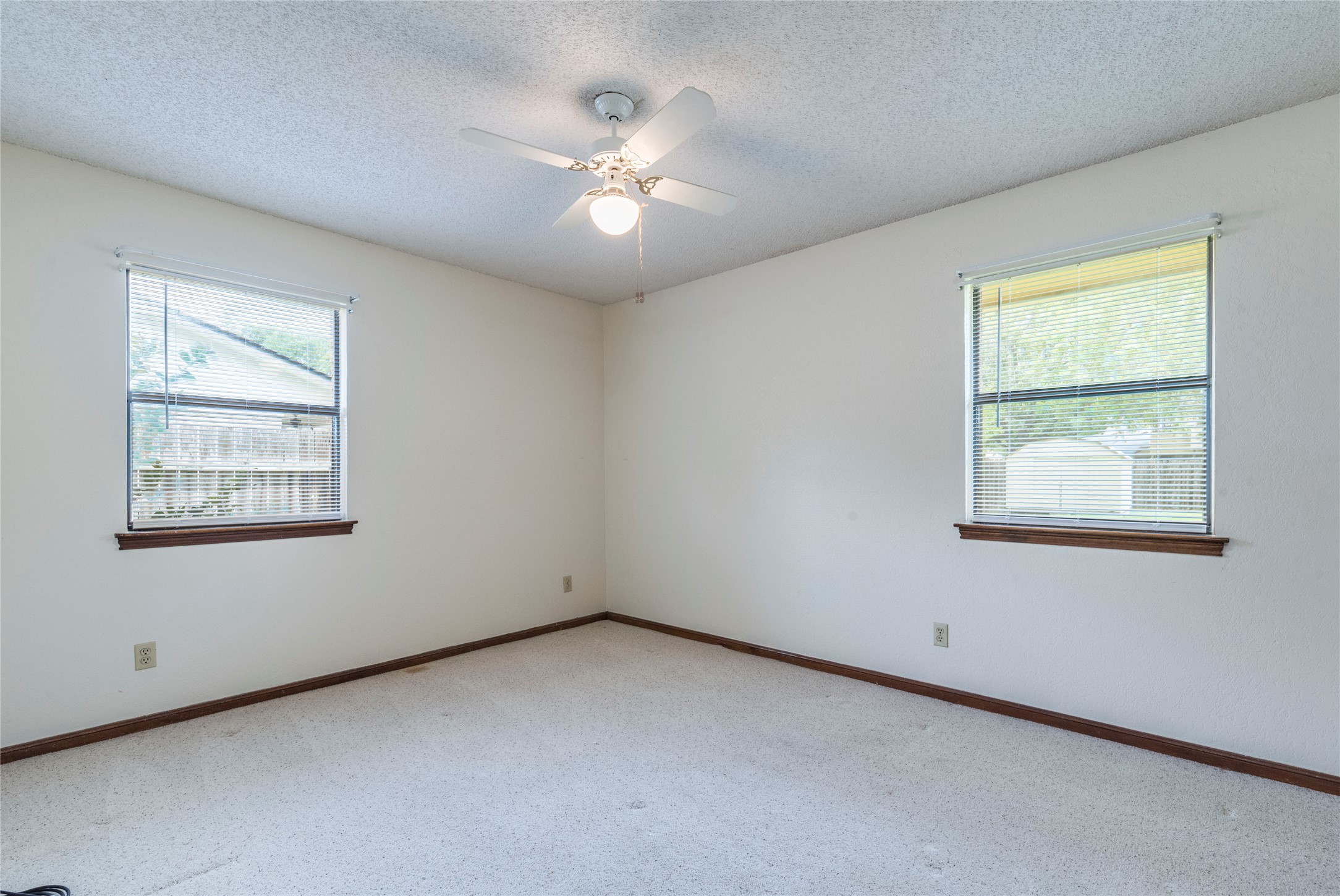 13505 Broadmeade Avenue Austin, TX 78729 - Photo 15 of 21 Spare room with a textured ceiling, light carpet, and ceiling fan