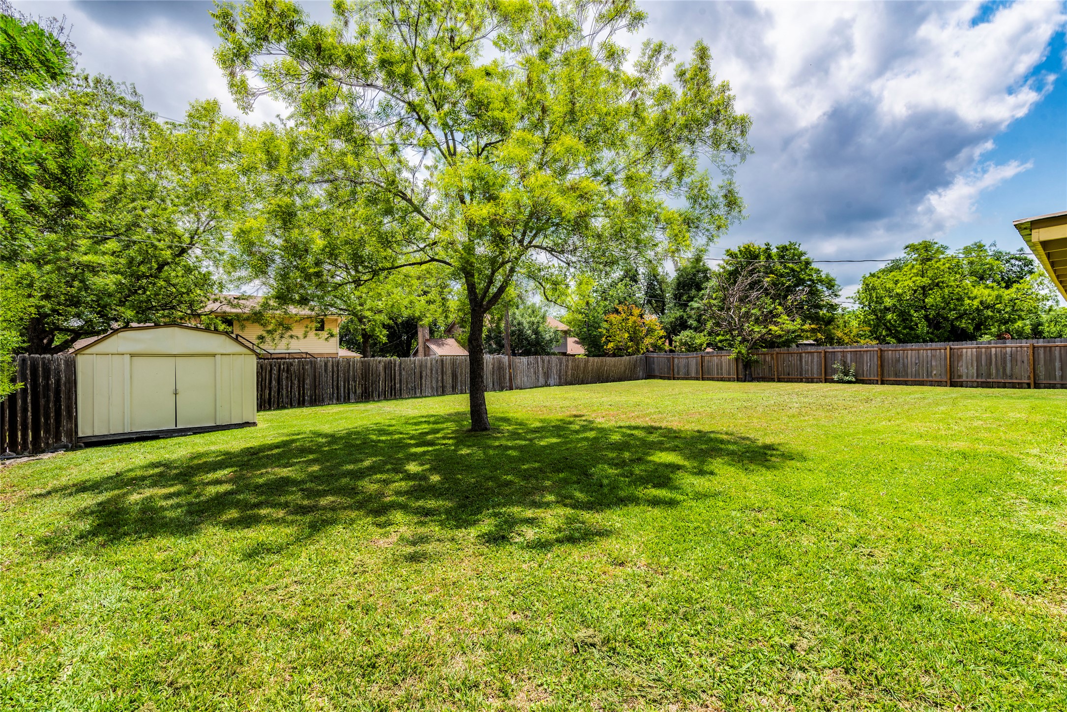 13505 Broadmeade Avenue Austin, TX 78729 - Photo 20 of 21 Fenced backyard with a shed