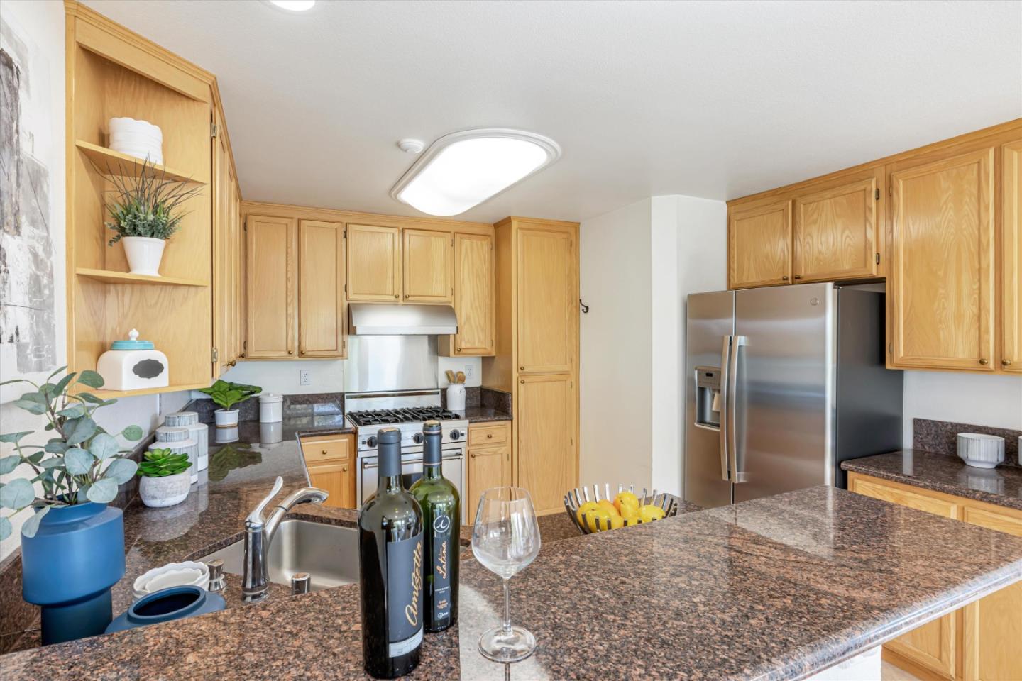 7863 Summerpointe Place Castro Valley, CA 94552 - Photo 11 of 43 a kitchen with stainless steel appliances granite countertop sink stove and refrigerator