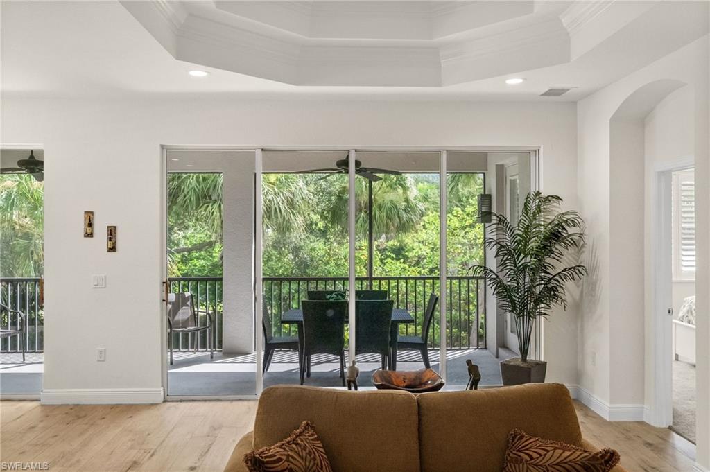 14562 Bellino Terrace, Unit 201 Bonita Springs, FL 34135 - Photo 14 of 46 a living room with furniture and a potted plant