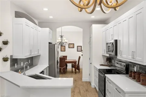 a kitchen with stainless steel appliances kitchen island granite countertop a sink and cabinets