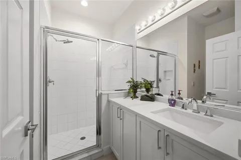 a bathroom with a double vanity sink and mirror