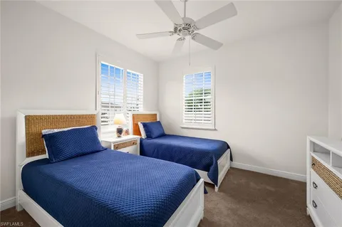 a bedroom with two beds and a window