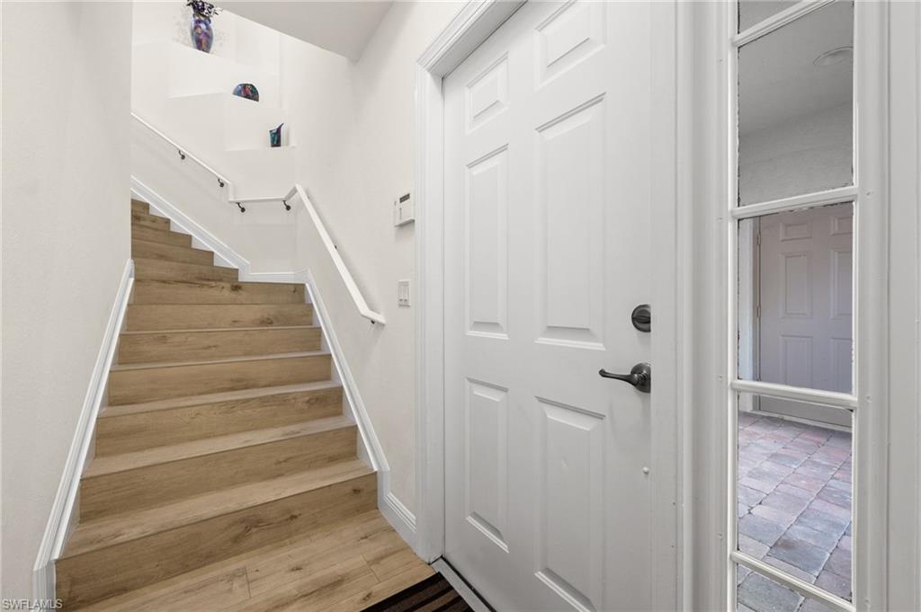 14562 Bellino Terrace, Unit 201 Bonita Springs, FL 34135 - Photo 30 of 46 a view of a hallway with stairs