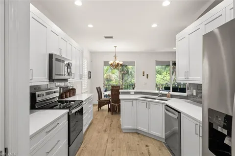 a kitchen with a sink stove top oven and refrigerator