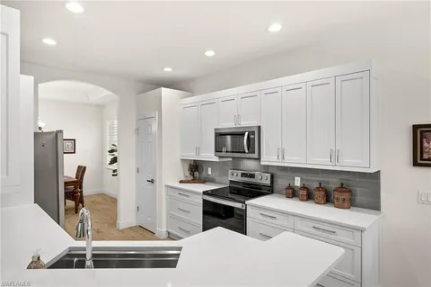 a kitchen with stainless steel appliances a stove a sink and a refrigerator