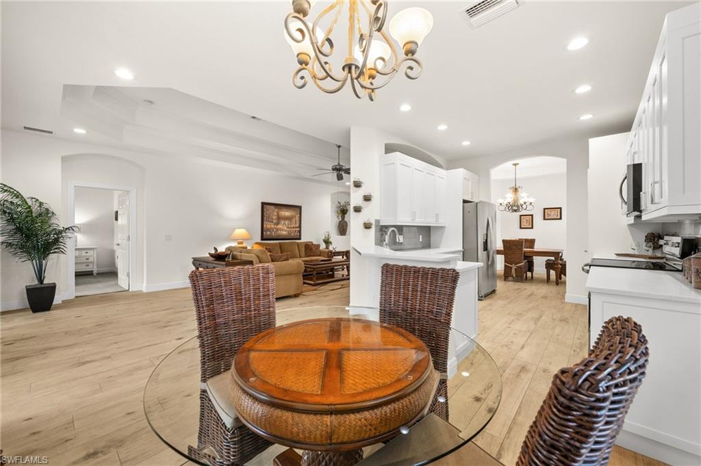 14562 Bellino Terrace, Unit 201 Bonita Springs, FL 34135 - Photo 6 of 46 a living room with furniture a dining table and kitchen view