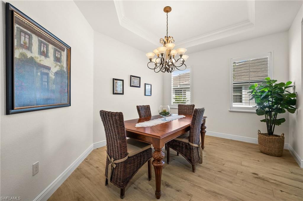 14562 Bellino Terrace, Unit 201 Bonita Springs, FL 34135 - Photo 8 of 46 a view of a dining room with furniture window and wooden floor