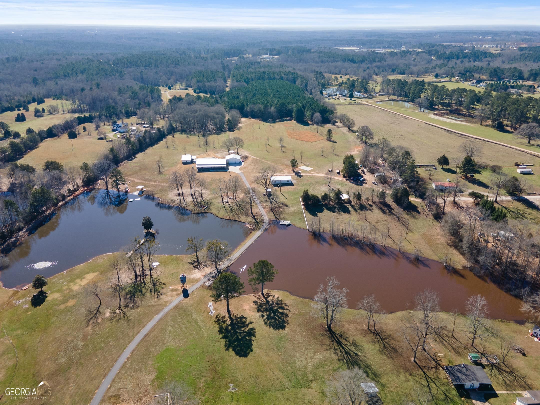 102 Cleveland Road Locust Grove, GA 30248 - Photo 1 of 1 an aerial view of a city with mountains