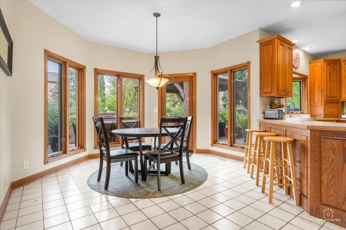 601 Ridgelawn Trail Batavia, IL 60510 - Photo 17 of 57 a dining room with furniture a chandelier and wooden floor