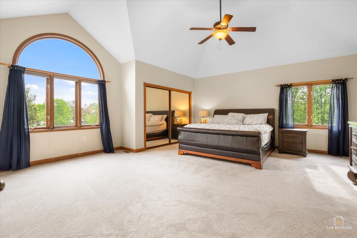 601 Ridgelawn Trail Batavia, IL 60510 - Photo 24 of 57 a bedroom with a bed and a chandelier