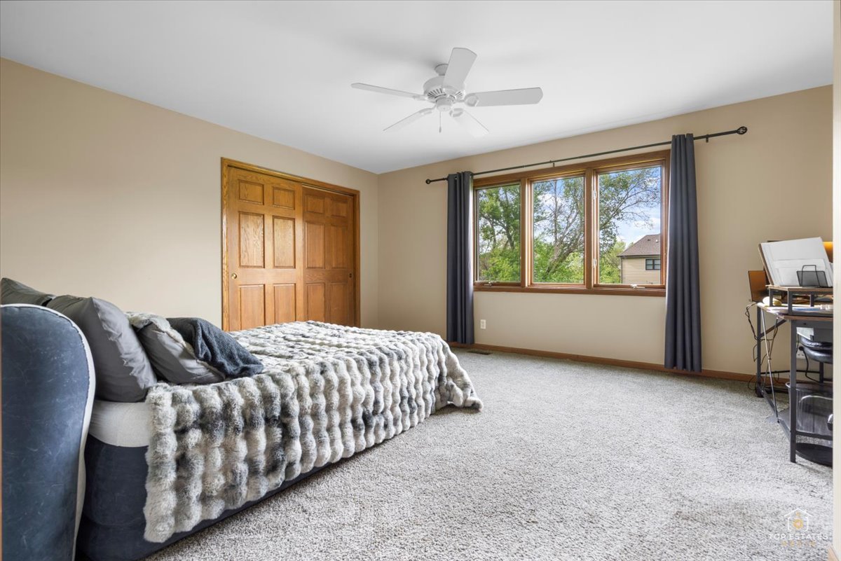 601 Ridgelawn Trail Batavia, IL 60510 - Photo 27 of 57 a bedroom with a large bed and a window