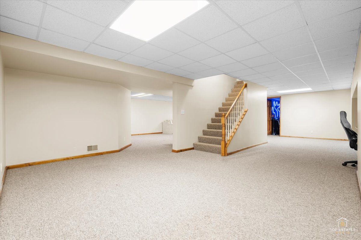601 Ridgelawn Trail Batavia, IL 60510 - Photo 32 of 57 a view of a room with stairs and white walls