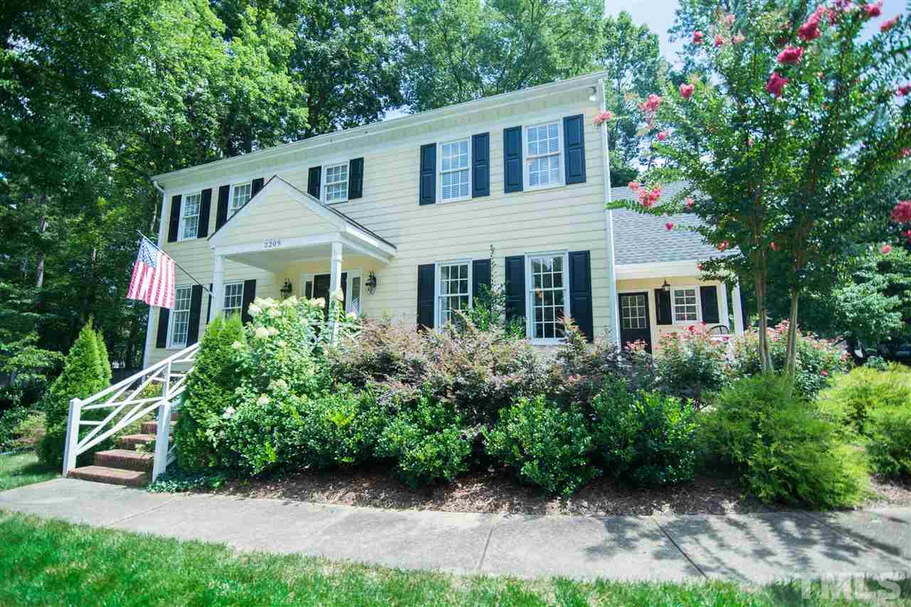 2209 Basil Drive Raleigh, NC 27612 - Photo 1 of 25 a front view of a house with a yard and potted plants