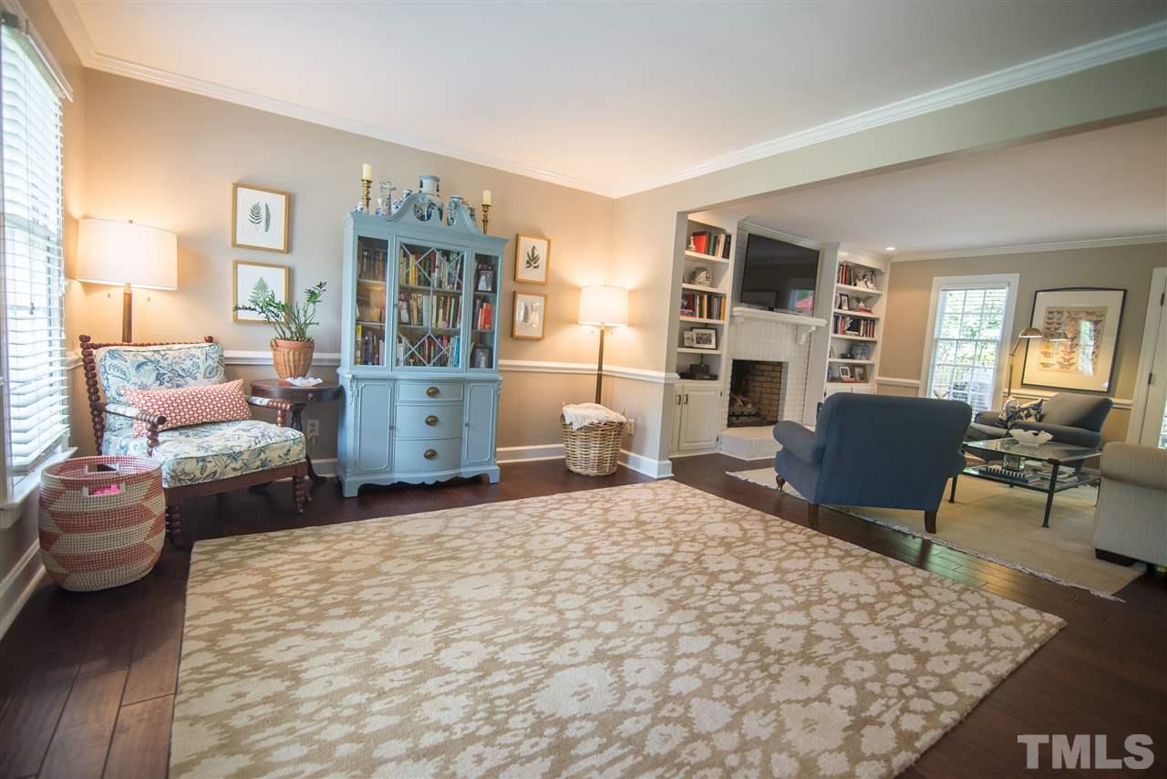 2209 Basil Drive Raleigh, NC 27612 - Photo 4 of 25 a bedroom with furniture and a fireplace
