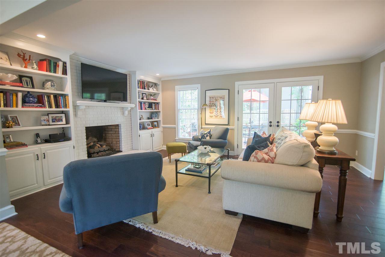 2209 Basil Drive Raleigh, NC 27612 - Photo 7 of 25 a living room with fireplace furniture and a flat screen tv